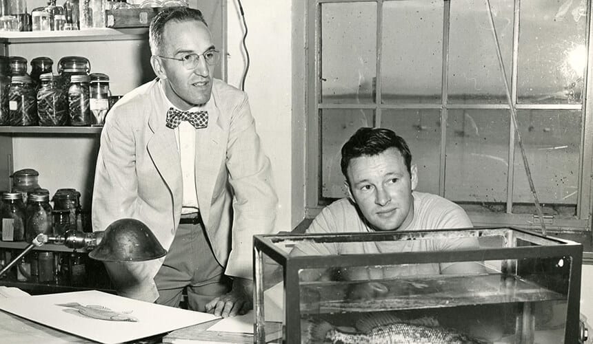 Professor Hasler examines a Micropteen Salmoides, caught by a colleague in Lake Mendota, August 1948.