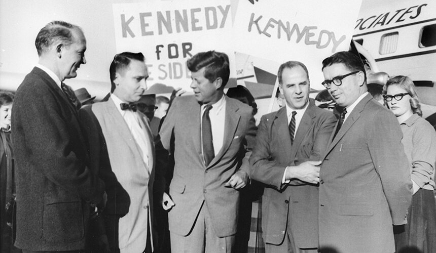 Presidential candidate John F. Kennedy at the Madison airport with state Democratic leaders. To Kennedy's left are Governor Gaylord Nelson and state Democratic Party head Patrick J. Lucey. Ivan Nestingen, the mayor of Madison, is on the far right and directly to Kennedy's right is Marvin Brickson, head of the Madison Federation of Labor.