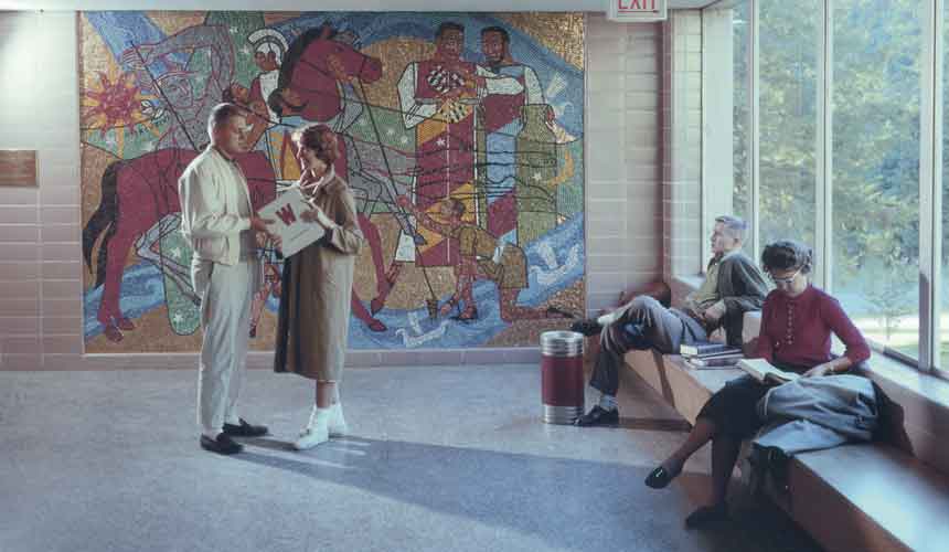 Students relax in front of James Watrous' mosaic "Ancient Commerce".