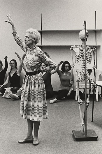 Margaret H'Doubler dancingth her favorite sidekick a skeleton in the background..