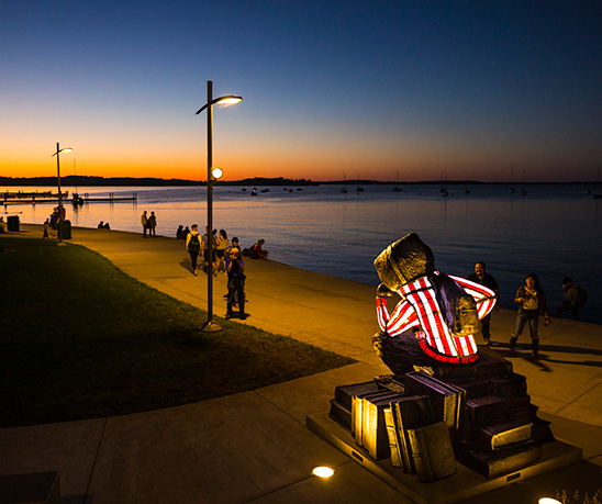 Well Red Bucky overlooking Lake Mendota during a sunset