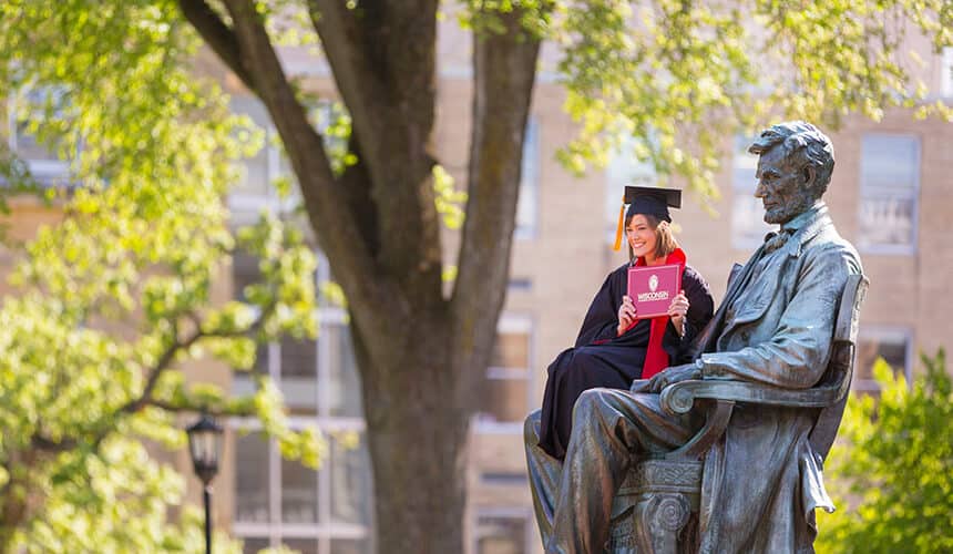 Student sitting on the lab of the Abe statue