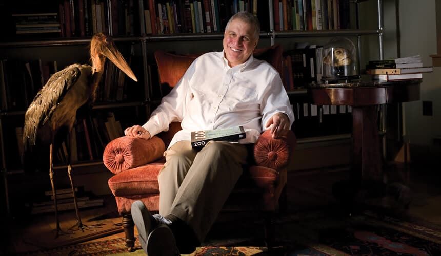 Errol Morris sitting in a chair.