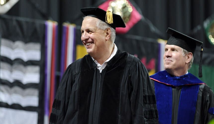 Errol Morris smiles during a commencement ceremony.