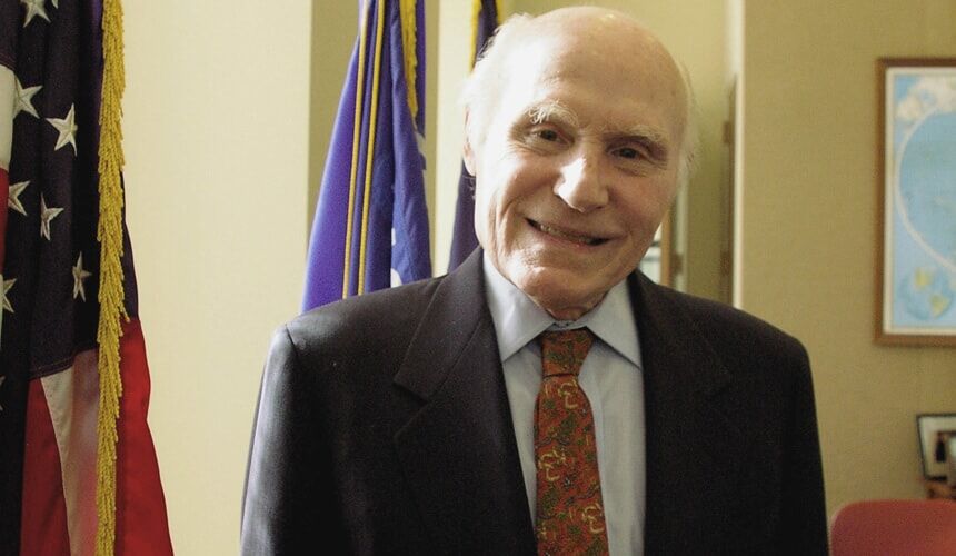Senator Herbert Kohl standing by an American flag in his Washington, D.C. office. 2011. (Image courtesy of the Wisconsin Historical Society.) Senator Herbert H. Kohl, Russ Feingold, and Hillary Clinton in his office.