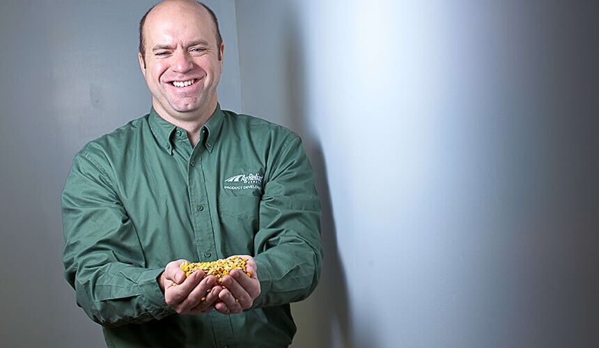 Koch manages genetics that are tested yearly in 35 countries. (Photo by Mike Randolph.) Tom Koch with a handful of corn.