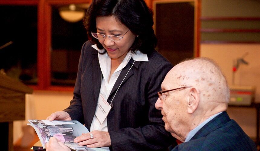 William Young speaking to Thailand’s deputy minister of education during a visit to Edgewood College in 2003.