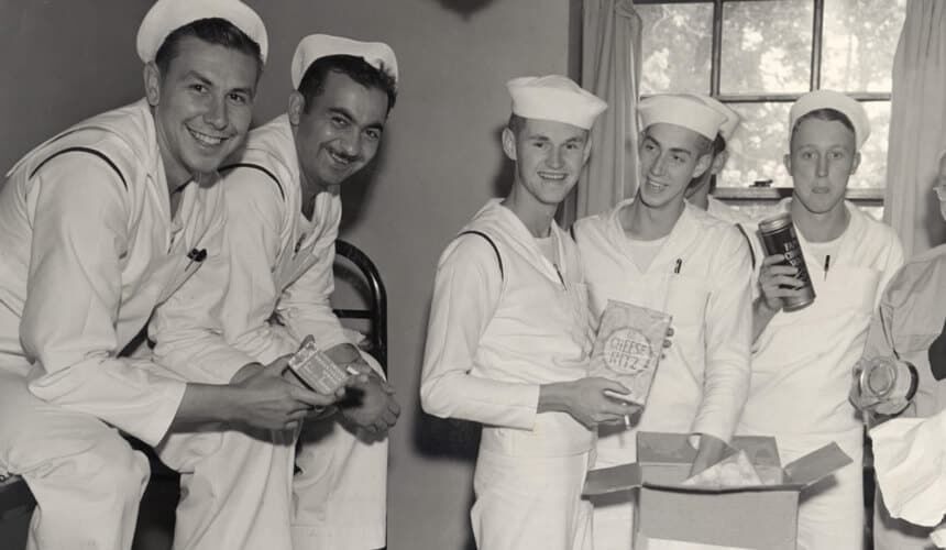 UW naval cadets receive care packages from home during World War II. (Image courtesy of the UW Digital Collections Center.) UW naval cadets smile as they receive care packages from home during World War II