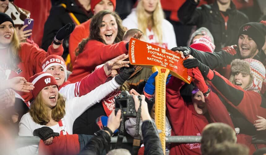 Badger fans touch the Paul Bunyan Axe after beating Minnesota.