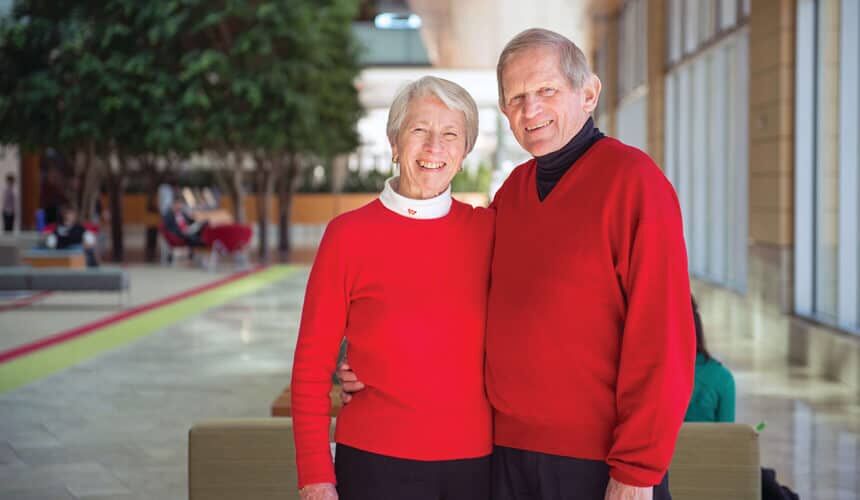John graduated in 1955 with a business degree, and Tashia with an education degree. (Photo by David Nevala.) The Morgridges pose and smile for the camera.