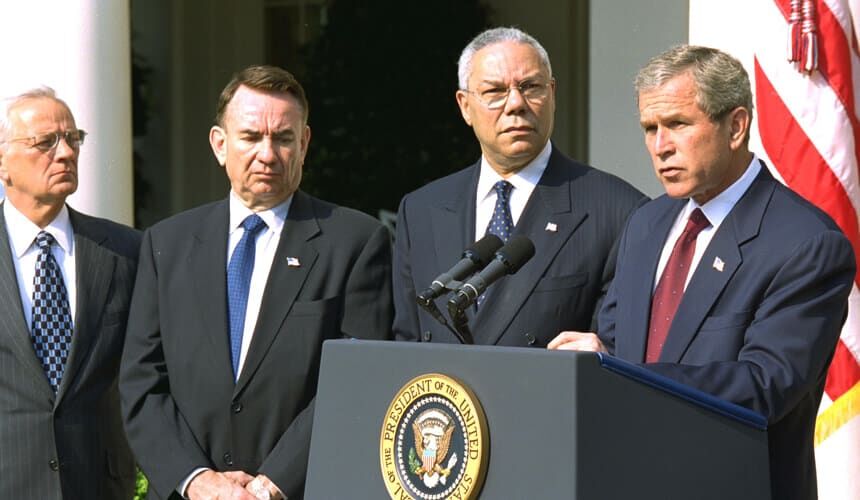 President George W. Bush announces a new Mother and Child HIV Prevention Initiative in the Rose Garden 19 June 2002. Standing by the President from, left to right, are Secretary of Treasury Paul O'Neill, Secretary of Health and Human Services Tommy Thompson and Secretary of State Colin Powell