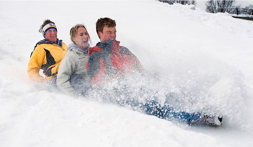 Students sledding on lunch trays