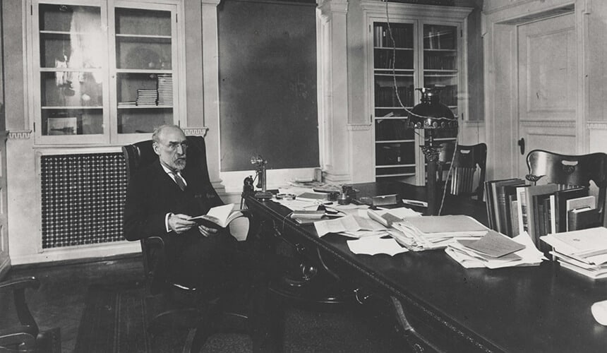 Charles Van Hise sitting at his desk in Bascom Hall.