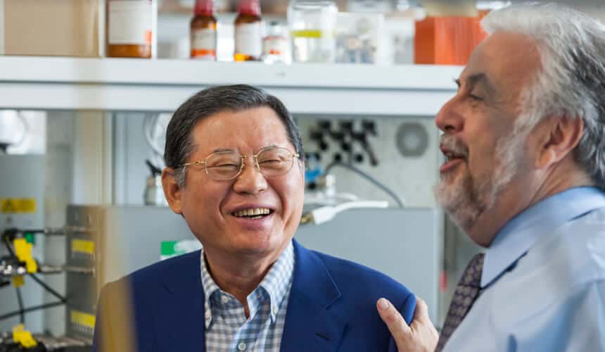 Hur Dong-Soo laughing in lab with colleague.